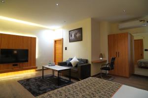a living room with a couch and a table at Hotel Kunadan Courtyard in Gwalior