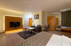 a hotel room with a bed and a television at Hotel Kunadan Courtyard in Gwalior +7 photos