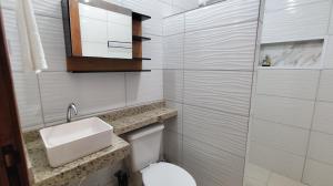 a white bathroom with a toilet and a sink at Pousada Solar Encanto do Marajó in Soure +76 photos