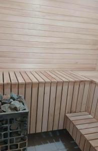 a wooden sauna with a bench and a pile of rocks at Hill House in Slobozia-Măgura +2 photos
