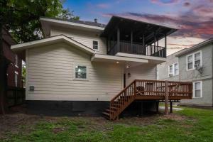 a large white house with a porch and a deck at Memphis Midtown Oasis in Memphis