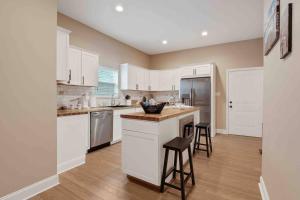 a kitchen with white cabinets and a counter top at Memphis Midtown Oasis in Memphis