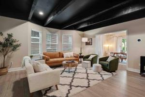 a living room with couches and chairs and a table at Memphis Midtown Oasis in Memphis