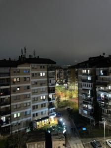 una vista di una città di notte con edifici di Bleon Apartment a Prizren