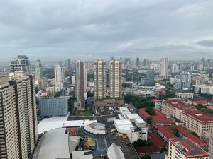 a city skyline with tall buildings in a city at Birch tower Condominium in Manila