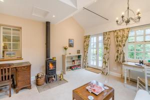 a living room with a fireplace and a table at 3 Bed in Comrie oc-e33307 in Comrie