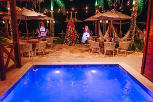 a swimming pool in front of a restaurant with christmas decorations at Lagoon Paradise in Fortim +91 photos