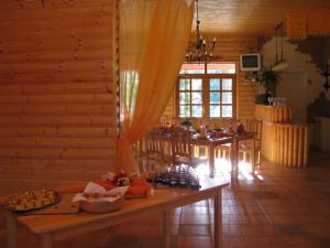 a dining room with a table with food on it at Guest House Gaujaspriedes in Gauja