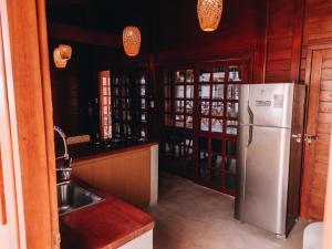 a kitchen with a refrigerator and a sink at Lagoon Paradise in Fortim