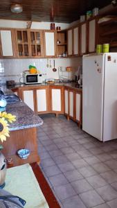 a kitchen with a white refrigerator and a tile floor at Alojamiento en Malargue in Malargüe