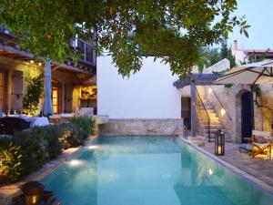 a swimming pool in the backyard of a house at Apokryfo Traditional Guesthouse in Lofou