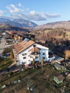 an aerial view of a house with mountains in the background at Pensiunea Tabacaru in Peştera