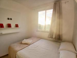 En eller flere senge i et værelse på Apto c/ varanda prox. da praia em Ilhéus RPD0301