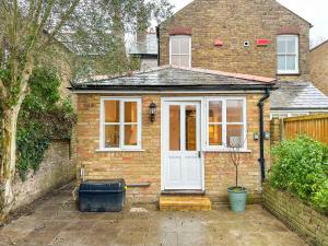 a brick house with a white door and window at Comfortable 3-Bed House near Canterbury Centre in Canterbury