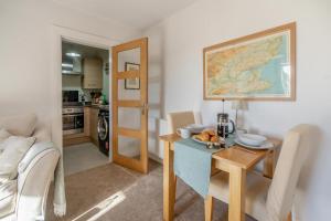 a living room with a table and a map on the wall at 1 Bed in Errol oc-s33022 in Errol +23 photos