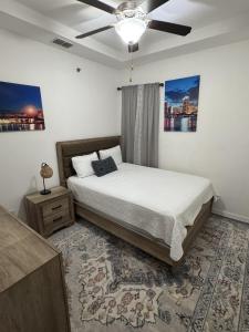 a bedroom with a bed and a ceiling fan at Fully Furnished 3BR and 2BA Gem Near Airport & Mall in McAllen