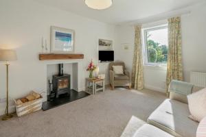 a living room with a couch and a fireplace at 1 Bed in Errol oc-s33022 in Errol