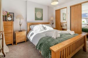 a bedroom with a large bed and a mirror at 1 Bed in Errol oc-s33022 in Errol