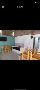 a living room with wooden chairs and a couch at El Atardecer in Villa Giardino