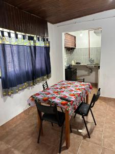 a table and chairs in a room with a kitchen at Alojamiento Paz in Esquina
