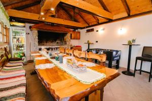 a long wooden table in a room with a fireplace at Kuća za odmor Jagnjić in Josipdol