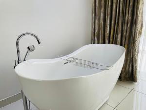 a white bath tub with a basket on top of it at Loreho boutique in Mahikeng