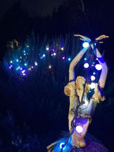 een standbeeld van een vrouw met lichtjes in een boom bij Appartementen Elzentuin in Oud-Beijerland