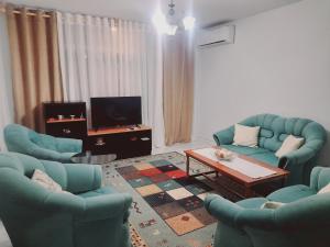 a living room with two chairs and a coffee table at Tirana center view in Tirana