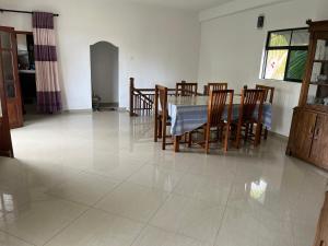 a dining room and kitchen with a table and chairs at Galle City Guest in Galle