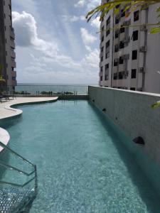 a swimming pool on the side of a building at Flat BV Beira-Mar - Edf Beach Class EXECUTIVE Apart-Hotel 507 in Recife