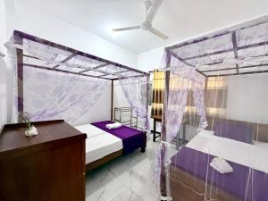 a bedroom with a bed with a mosquito net at Midigama Lucky Villa in Midigama East +60 photos