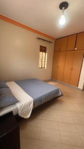 a bedroom with a bed and a window at Pure Haven in Mbale