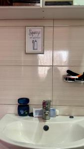 a bathroom sink with a sign on the wall at Pure Haven in Mbale +10 photos