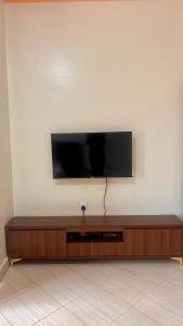 a flat screen tv sitting on a wall at Pure Haven in Mbale