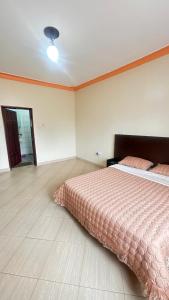 a bedroom with a large bed in a room at Pure Haven in Mbale