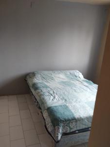 a bed sitting in a corner of a room at Depto TOMY in Mar de Ajó