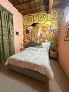 a bedroom with a bed with a painting on the wall at L'Abbraccio in Tivoli