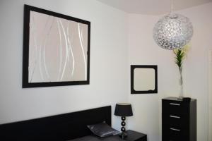 a bedroom with a bed and a mirror and a dresser at Apartment on Rue De France 4 in Nice