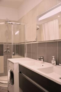 a bathroom with a sink and a washing machine at Apartment on Rue De France 4 in Nice