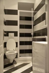 a black and white bathroom with a toilet and a sink at Apartment on Rue De France 4 in Nice