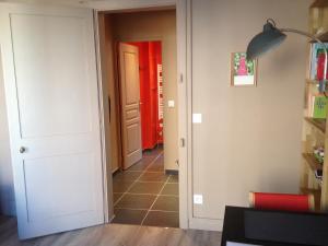 a hallway with a red door and a room at Côté Saint-Léonard - Honfleur in Honfleur