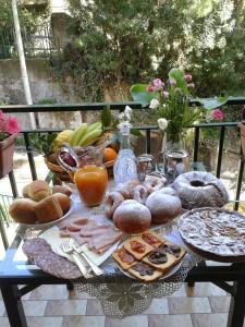 a table full of food and fruit on a table at La Sorgente B&B in Cetara