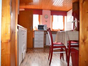 a small kitchen with a table and a microwave at Holiday Home Sequoia by Interhome in Hahnenklee-Bockswiese
