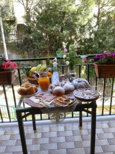 a table with food and drinks on a balcony at La Sorgente B&B in Cetara