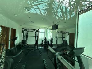 a gym with treadmills and ellipticals in a room at RM Beach Paradise - Barra Iloa Residense in Barra de São Miguel