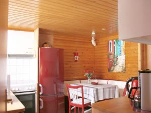 a kitchen with a table and a red refrigerator at Holiday Home Sequoia by Interhome in Hahnenklee-Bockswiese