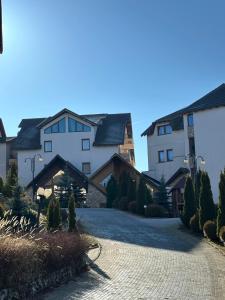 a road in front of a large building at Mountain Hearth - Milmari Resort in Kopaonik