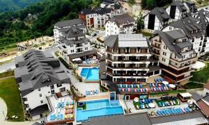 an aerial view of a resort with a pool and buildings at Mountain Hearth - Milmari Resort in Kopaonik
