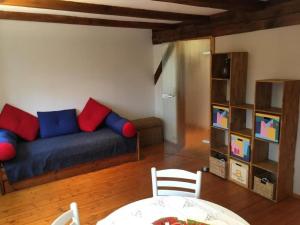 a living room with a blue couch with red and blue pillows at Apartment Kastanienblick by Interhome in Ziethen