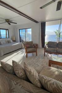 una camera da letto con un letto, un divano e un tavolo di Maalaea Oceanfront Condo a Wailuku